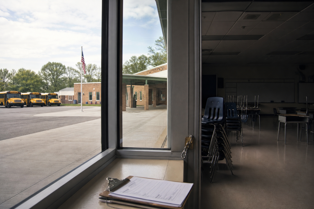 Empty classroom and parked school buses at a quiet public school campus