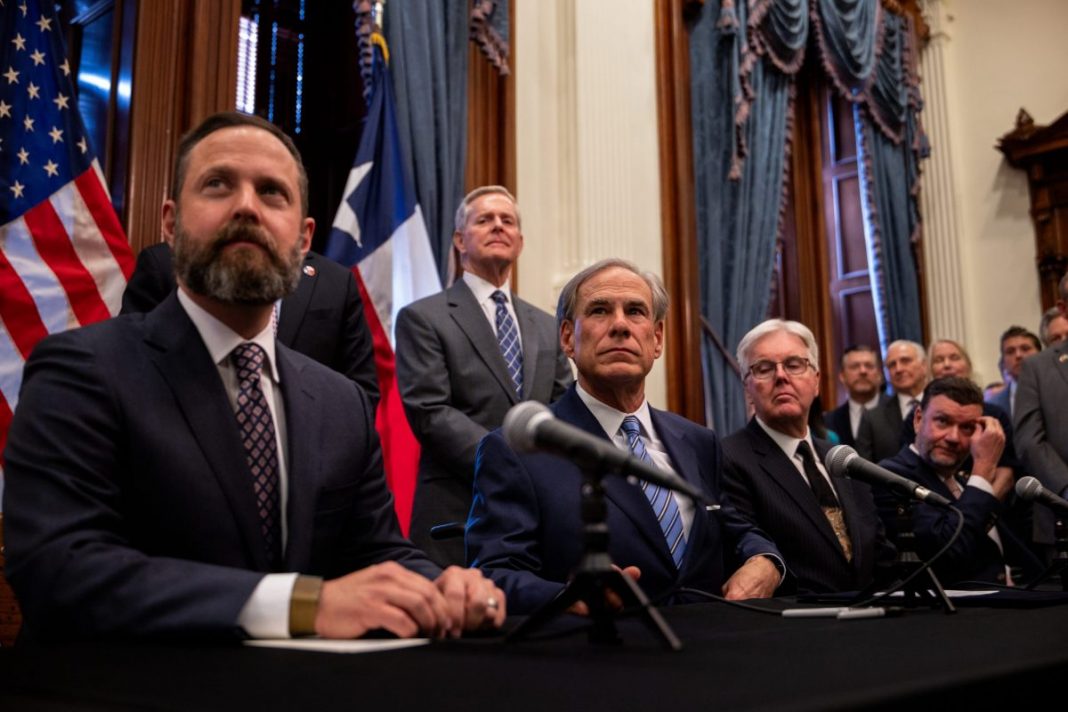 From left, House Speaker Dustin Burrows, Gov. Greg Abbott and Lt. Gov. Dan Patrick hold a bill-signing ceremony at the Texas Capitol on April 23, 2025, to create a Texas Department of Government Efficiency.
