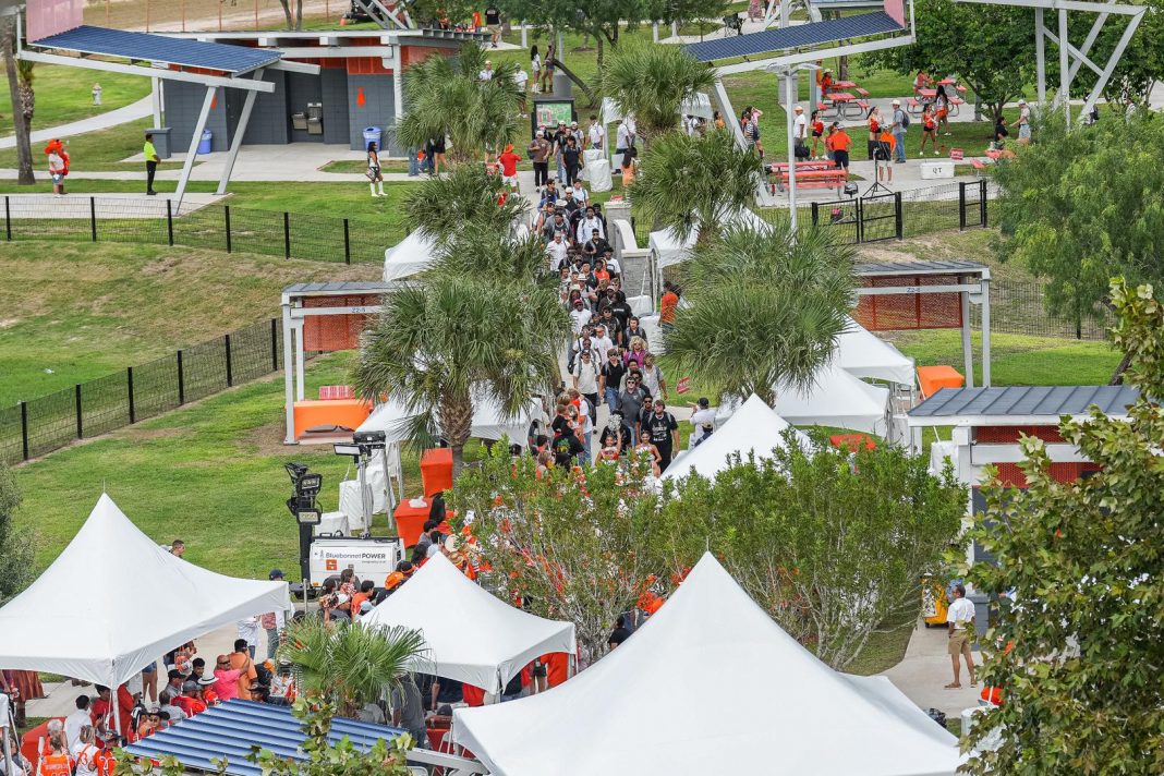 Fans gather in a UTRGV football tailgating area.
